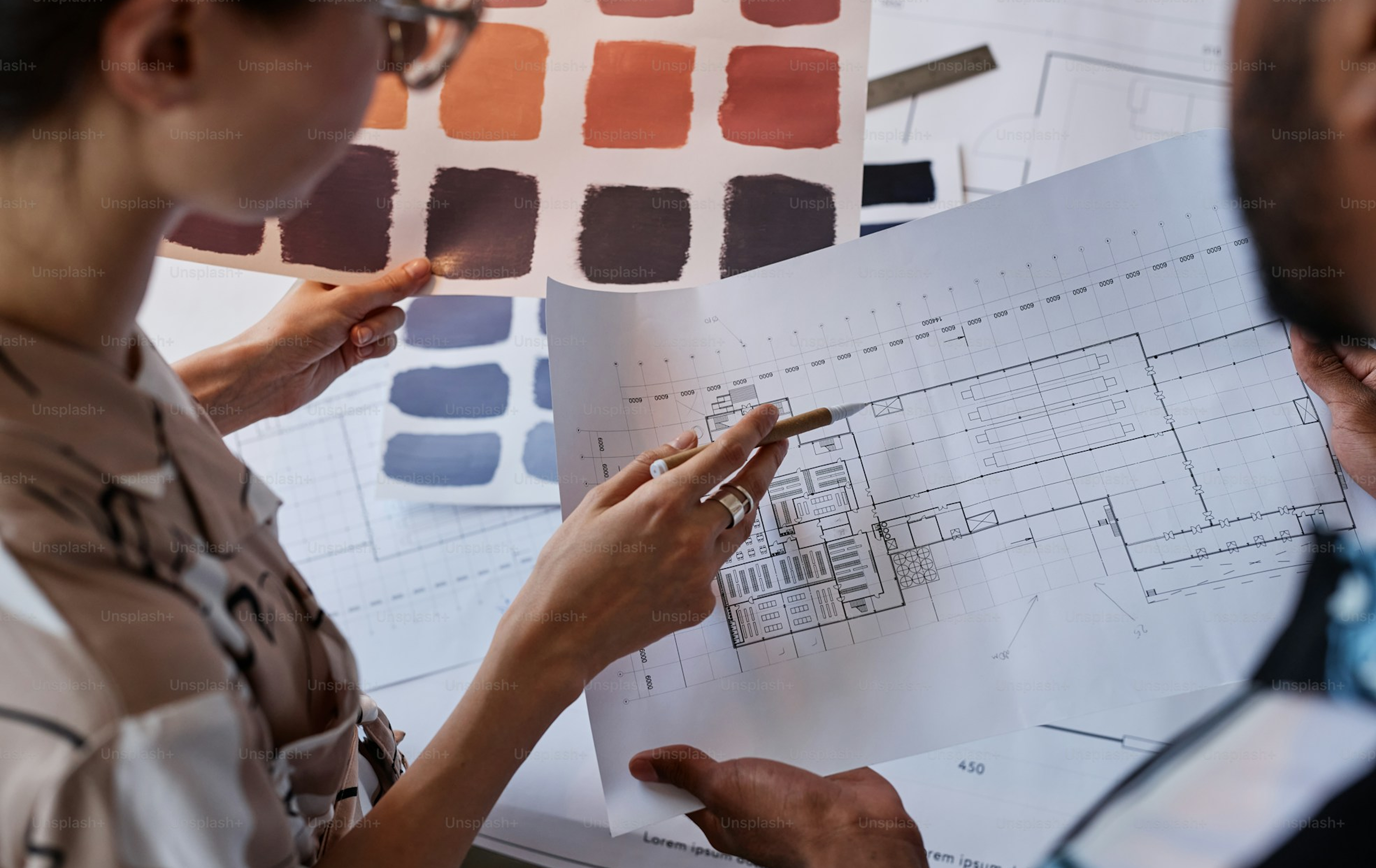Interior designers reviewing material swatches and drawings